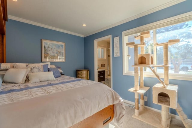 carpeted bedroom with crown molding and connected bathroom