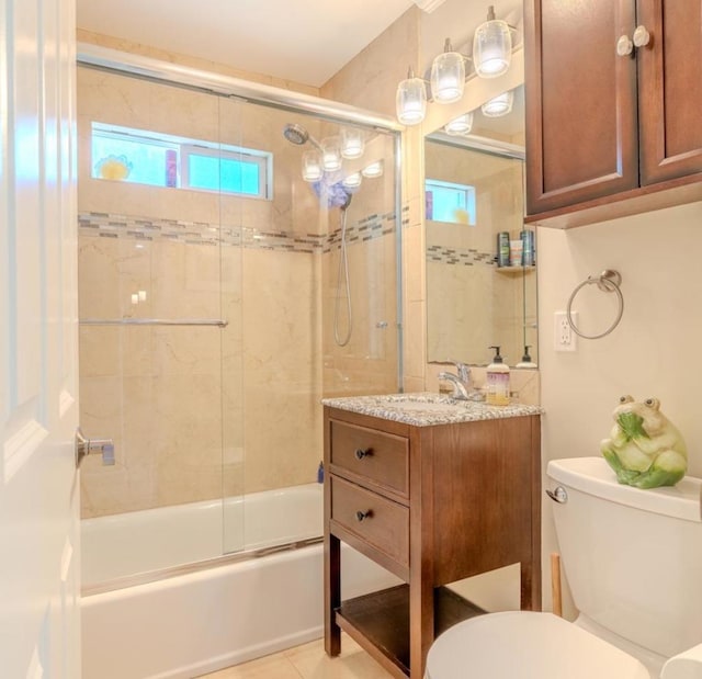 full bathroom with toilet, enclosed tub / shower combo, tile patterned floors, and vanity