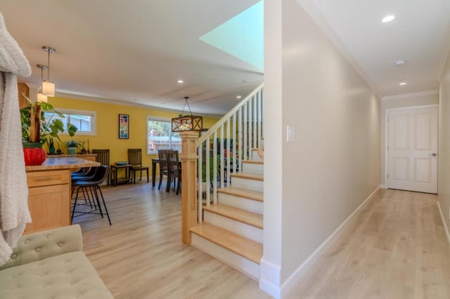 stairway with crown molding and hardwood / wood-style flooring