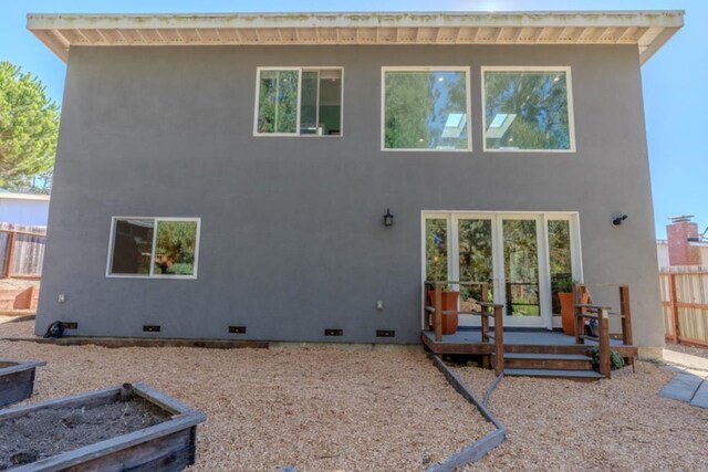 rear view of house featuring a wooden deck