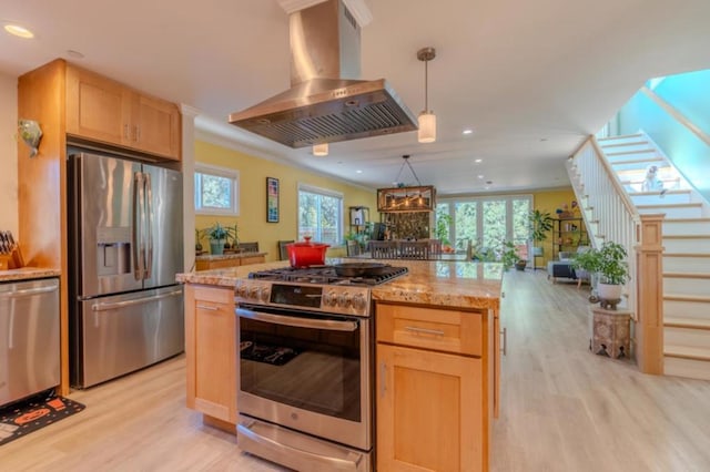 kitchen featuring ventilation hood, stainless steel appliances, decorative light fixtures, ornamental molding, and light hardwood / wood-style flooring