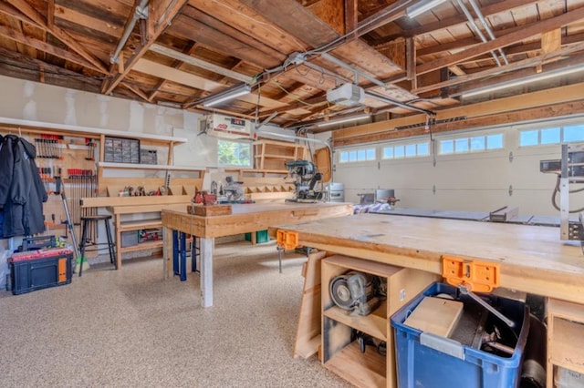 garage with a garage door opener and a workshop area