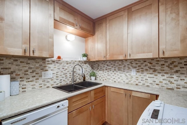 kitchen featuring dishwasher, tasteful backsplash, and sink