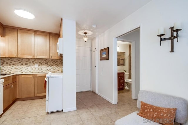 kitchen with stove, light tile patterned floors, dishwasher, and tasteful backsplash