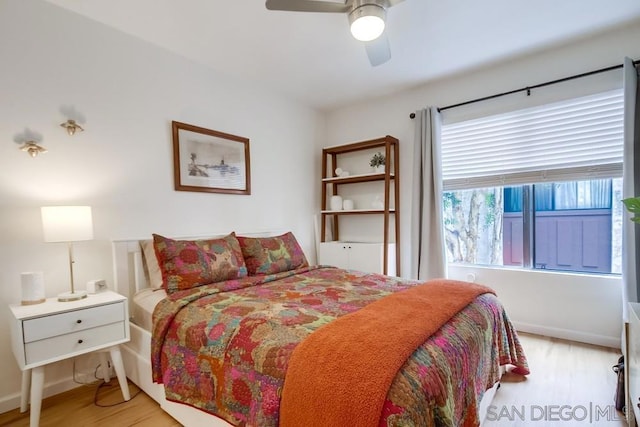 bedroom with ceiling fan and light hardwood / wood-style floors