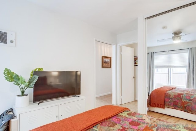 bedroom with ceiling fan and light hardwood / wood-style flooring