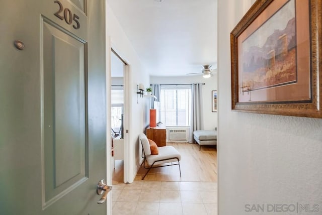 hall featuring light tile patterned flooring