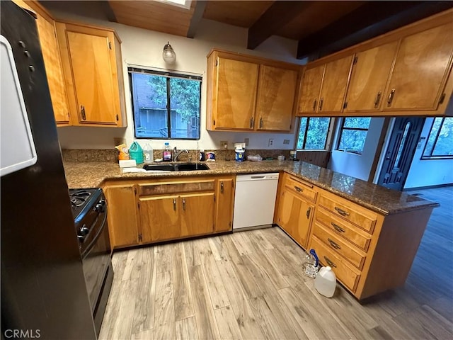 kitchen with black appliances, sink, kitchen peninsula, light hardwood / wood-style flooring, and beam ceiling