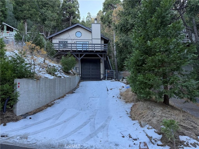 view of property featuring a wooden deck and a garage