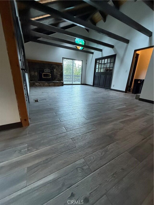 unfurnished room featuring hardwood / wood-style floors and beamed ceiling