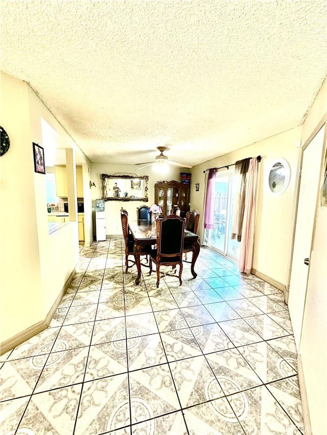 dining space with a textured ceiling and ceiling fan