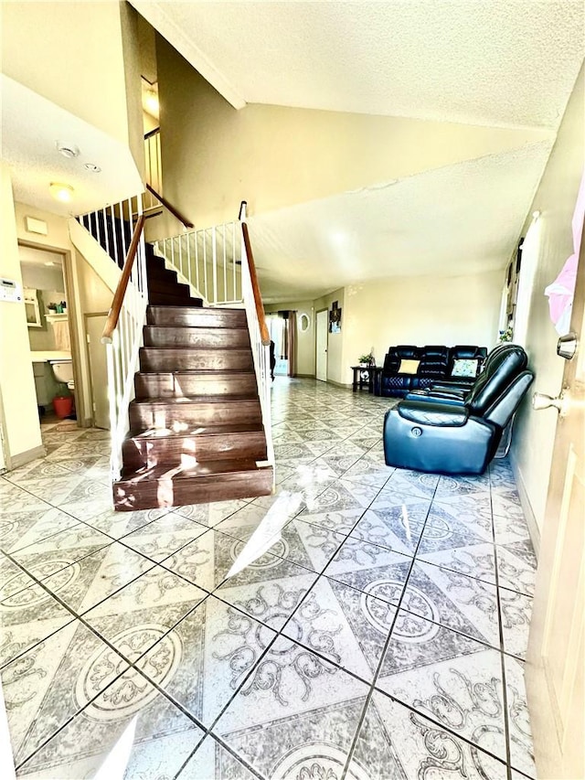 stairs with vaulted ceiling