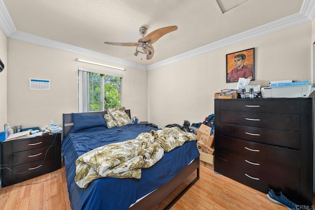 bedroom featuring ceiling fan, light hardwood / wood-style floors, and crown molding