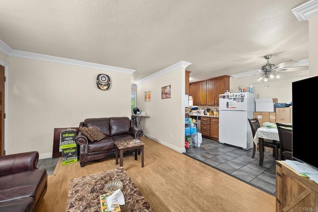 living room with ceiling fan, dark hardwood / wood-style floors, and crown molding