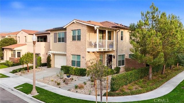 view of front of home featuring a garage, solar panels, and a balcony