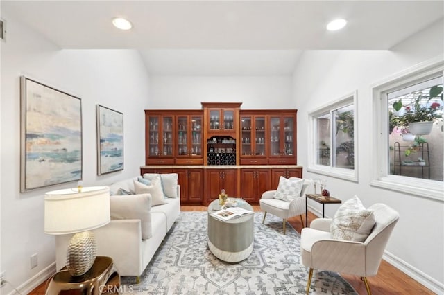 interior space with lofted ceiling and light hardwood / wood-style flooring