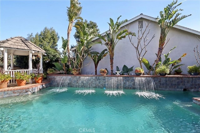 view of swimming pool with a gazebo and pool water feature