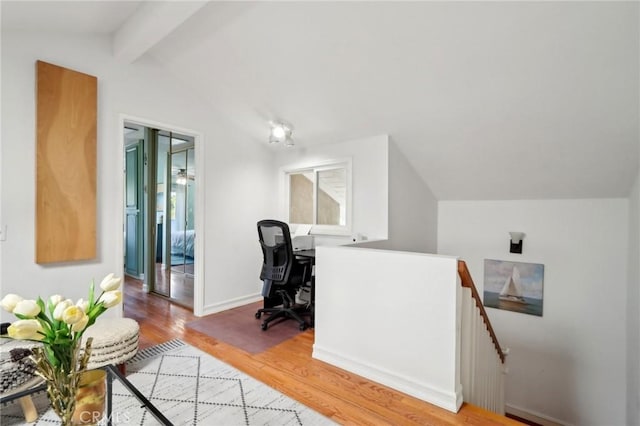 office featuring wood-type flooring, lofted ceiling with beams, and a healthy amount of sunlight