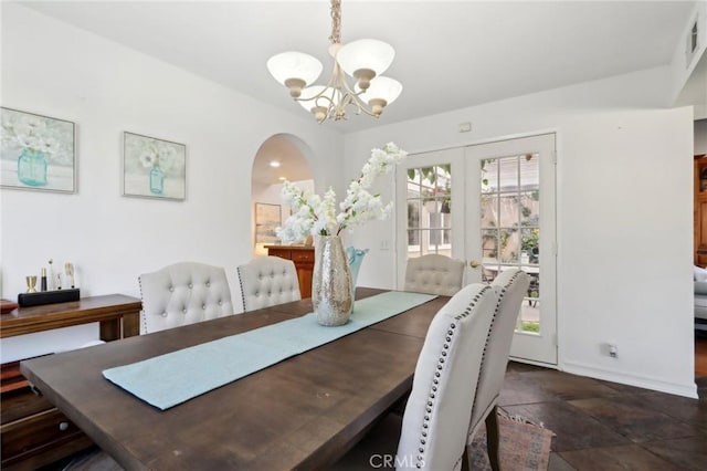 dining space featuring a chandelier and french doors