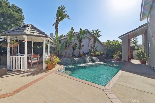 view of swimming pool with a gazebo, pool water feature, and a patio