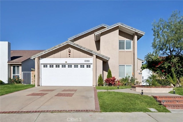 view of front of house featuring a garage and a front lawn