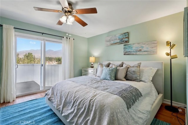 bedroom featuring ceiling fan, wood-type flooring, and access to exterior