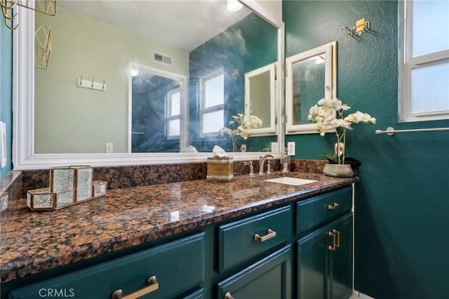 bathroom with vanity and a healthy amount of sunlight