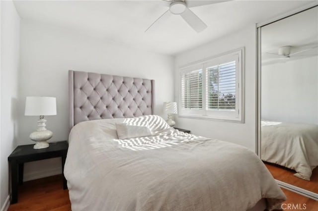 bedroom with dark wood-type flooring and ceiling fan