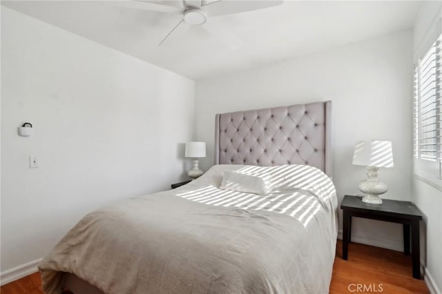 bedroom featuring hardwood / wood-style flooring and ceiling fan