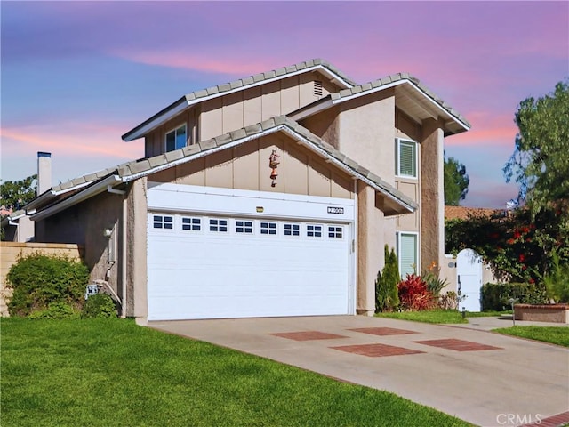 view of front facade with a garage and a yard