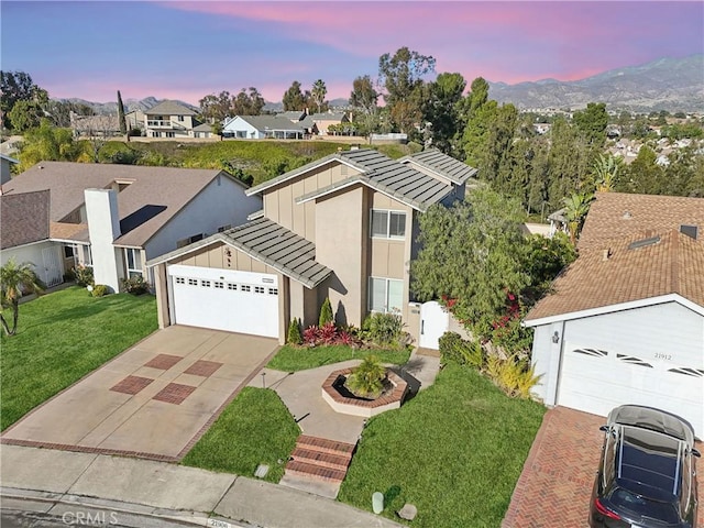 view of front of house with a garage and a lawn