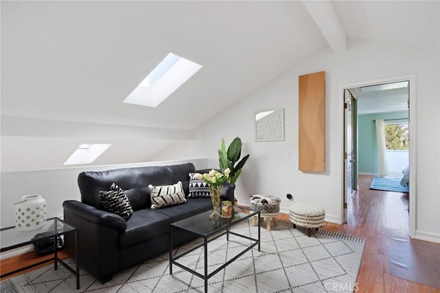 living room with lofted ceiling with skylight and wood-type flooring