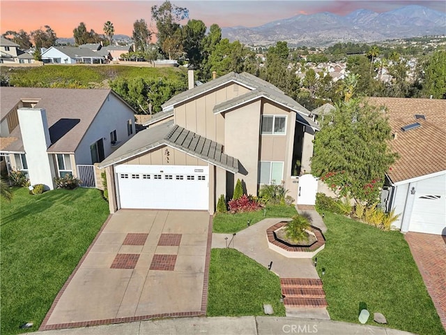 view of front facade with a garage and a lawn