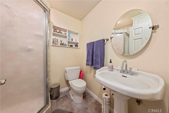 bathroom with sink, toilet, and an enclosed shower