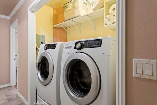 washroom featuring ornamental molding and washing machine and dryer