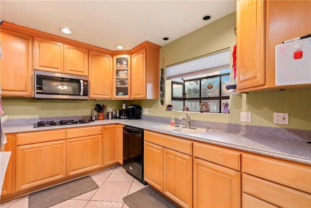 kitchen with light tile patterned floors, sink, and black appliances