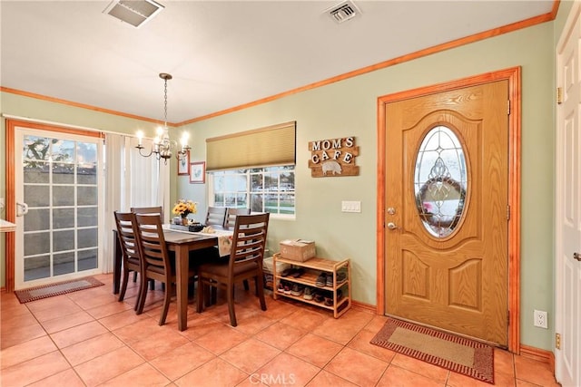 dining space with plenty of natural light, light tile patterned floors, crown molding, and a chandelier