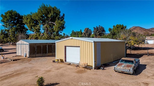 view of outdoor structure with a mountain view and a garage