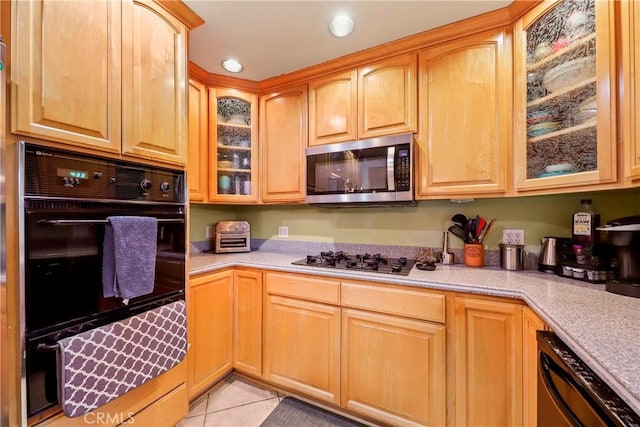 kitchen featuring light tile patterned floors and black appliances