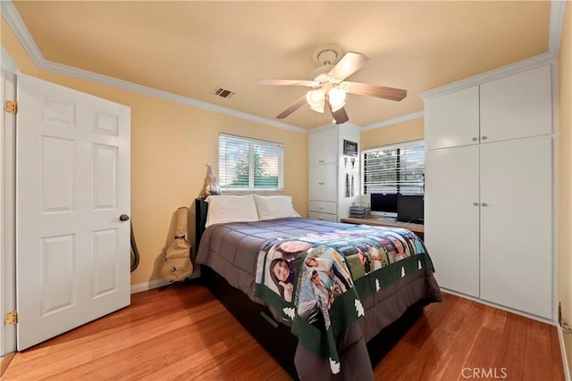 bedroom featuring ceiling fan, ornamental molding, a closet, and light hardwood / wood-style floors