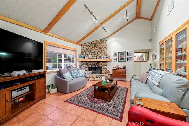 tiled living room featuring high vaulted ceiling, rail lighting, beam ceiling, and a fireplace