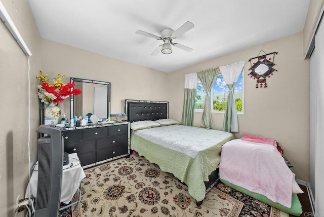 bedroom featuring ceiling fan and a closet