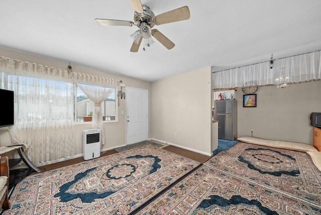 bedroom featuring ceiling fan and stainless steel refrigerator