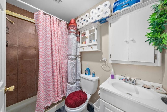 bathroom featuring toilet, vanity, and a shower with curtain