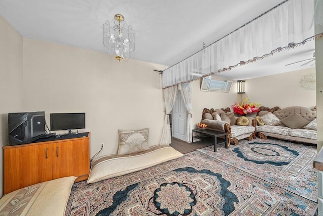 living room featuring an AC wall unit and a notable chandelier