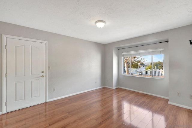 empty room with wood-type flooring