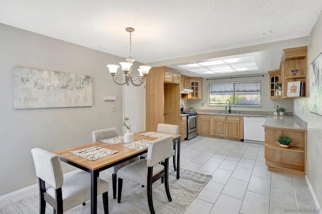 tiled dining room featuring sink and a notable chandelier