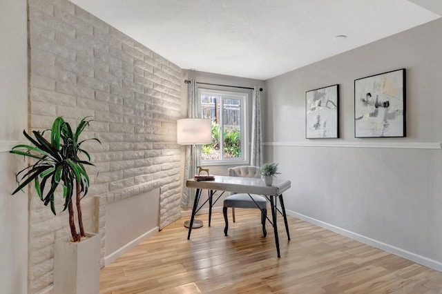 home office with light hardwood / wood-style flooring