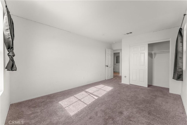 unfurnished bedroom with a closet and carpet