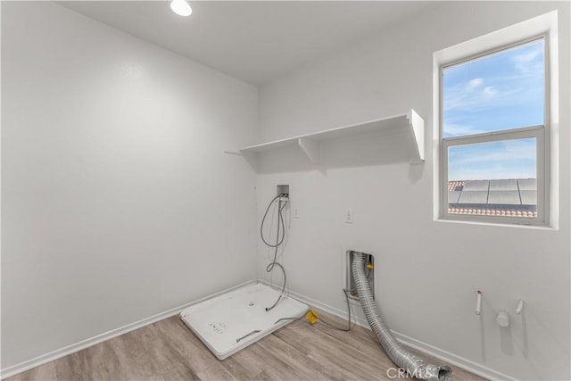 laundry area featuring washer hookup and hardwood / wood-style floors